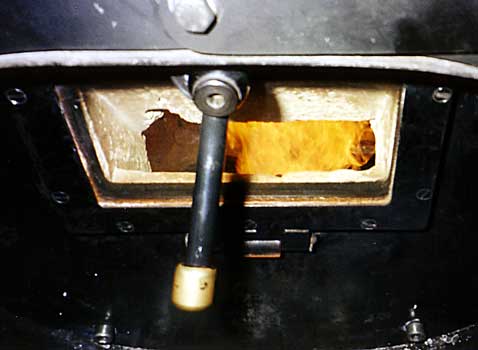 An interesting feature is glass in the firehole 'door', a door which requires bolts to be removed before it can be opened. As can be seen the window is surrounded by fire clay. When this photograph was taken the burner was on a very low setting whilst sat in Brienz station. August 16 2000