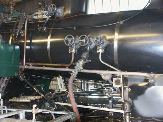 The centre valve is the exit point for boiler water on its' way to the preheater. The valves are proprietary pressure vessel fittings and not made specifically for this type of locomotive. October 8 2003