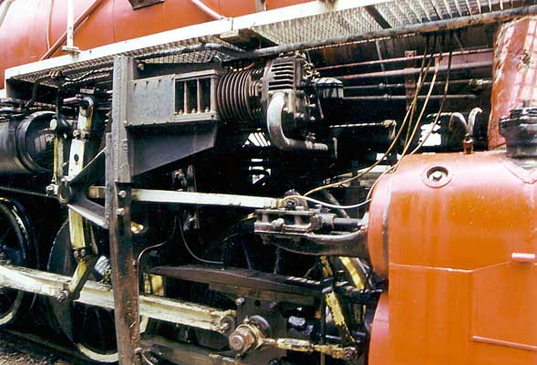 On each side of the loco converted Chinese built truck engines are set up as mechanical air brake pressure maintainers. Each is driven from an extension to the expansion link. 1999. © Shaun McMahon