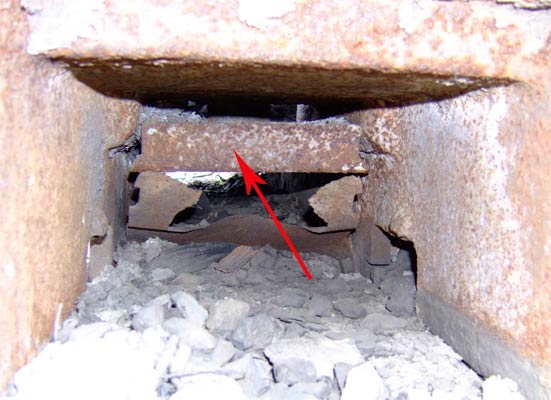 A view along the stoker trough looking from the grate end. The red arrow points to one part of the ram system used to push the coal towards the grate. 11 June 2006 