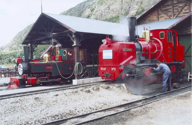 Winson built 2-6-2T FCAF No.3 Camila (left) stands in No.2 road 'Estacion Fin del Mundo' during a layover between duties. KM Class Garratt 0-4-0+0-4-0 FCAF No.2 'Ing. L.D.Porta' stands over the pit outside the workshops. See above for a view of No.2 in original condition. No.2 is being given a routine inspection and pressure wash. Both locos sport many modifications, perhaps the most prominent being the Lempor tapered chimneys and on No.2 the curved main steam pipe behind the dome. January 14 2003 &copy; Shaun McMahon
