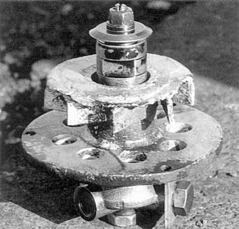 The heart of the beast. A burner unit removed for attention from a VoR loco. Note, apart from evident work erosion, the baseplate with steam holes, the swirl vanes above and the oil column centre. &copy; Shaun McMahon