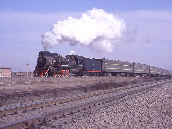 CNR JS 2-8-2 8279 heads a suburban passenger round the loop at Baotou. February 1999