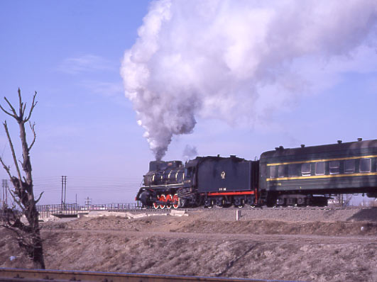 CNR JS 2-8-2 8279 heads a suburban passenger round the loop at Baotou. February 1999