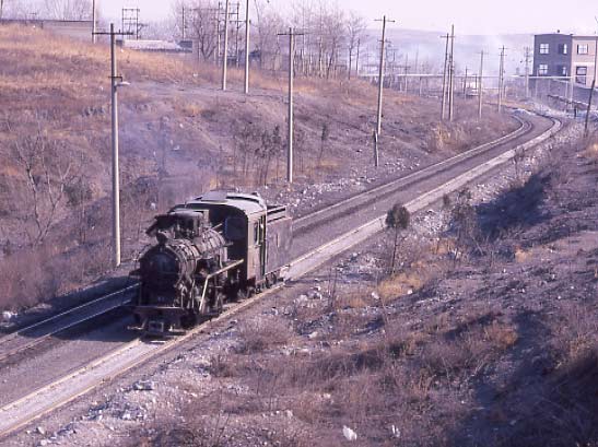 C2 Class 0-8-0 No.04 runs light towards the quarry at Dahuichang around 14:00. February 5 1999