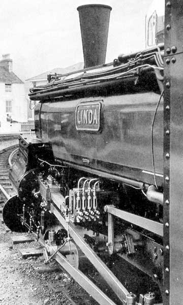 "Linda" at Porthmadog Harbour Station. Note the pipes carrying exhaust steam to the ashpan along the saddle tank. © N. Gurley 